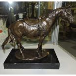 A bronze model of a horse, harnessed, on