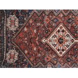 A Persian rug, with central white gul on