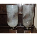 A pair of large hurricane lamps, the iri