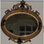 An oval gilt framed wall mirror, the fra