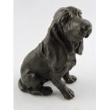 A cast bronze blood hound, seated with h