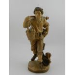 A carved wooden figurine of a man carryi
