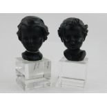 A pair of black glazed ceramic head and