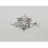 An 18ct white gold diamond daisy cluster