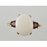 An opal and garnet dress ring, claw set