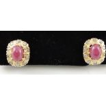 A pair of ruby and diamond ear studs, th