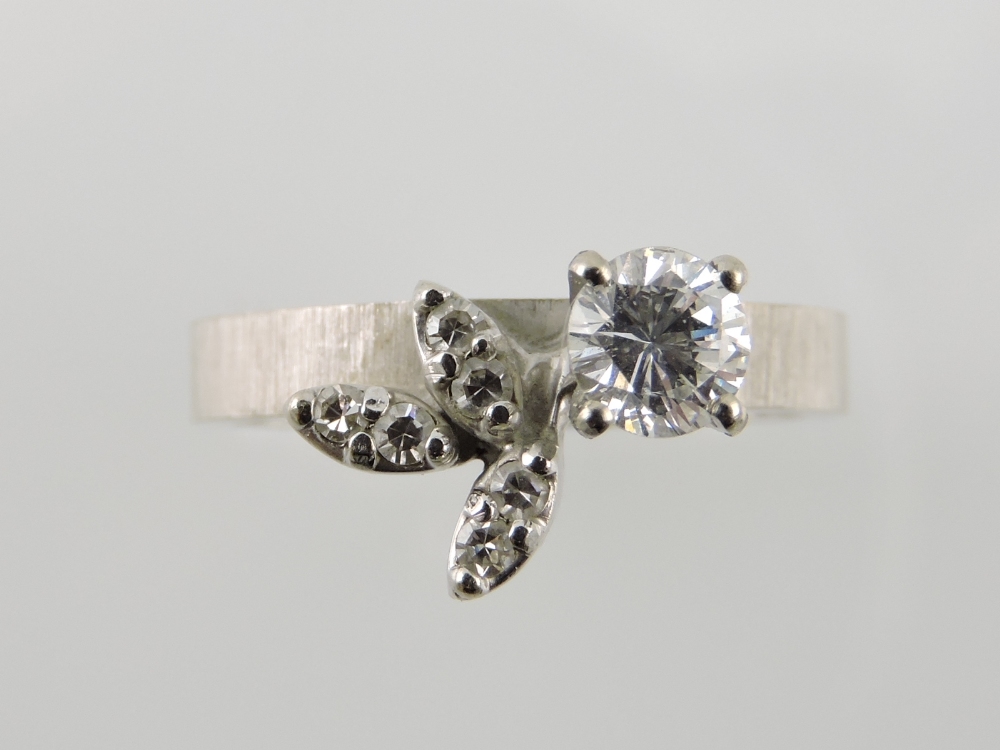 A diamond dress ring, with a single claw