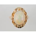 An opal dress ring, the oval stone in a