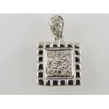 A diamond set square white metal pendant