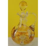 A cut glass decanter with a yellow overl
