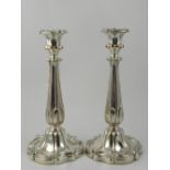 A pair of silver plated candle sticks. H