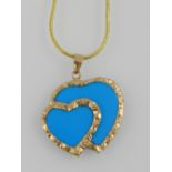 A yellow metal mounted double heart shaped turquoise pendant, indistinct mark to suspension loop,