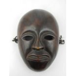 A West African carved hardwood mask.