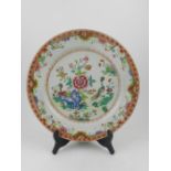 A Canton porcelain dish, polychrome decorated in the famille rose palate with exotic birds amongst