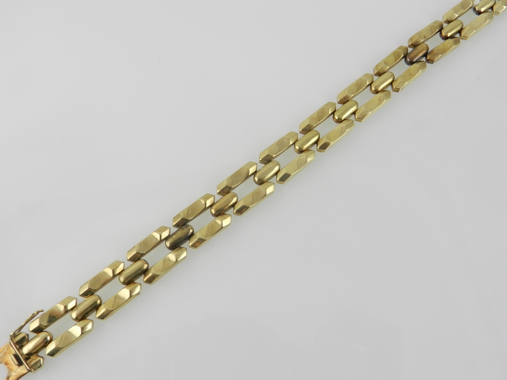 A yellow metal articulated link bracelet
