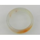 A Chinese agate bangle.