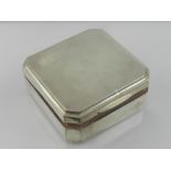 A silver mounted cigarette box with wood