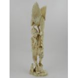 A Japanese Meiji period carved ivory okimono, a figural study of a falconer with bird of prey