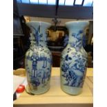 A pair of Chinese blue and white baluster vases, one having scrolling handles and decorated with