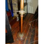 A wooden and gilt metal lamp raised on t