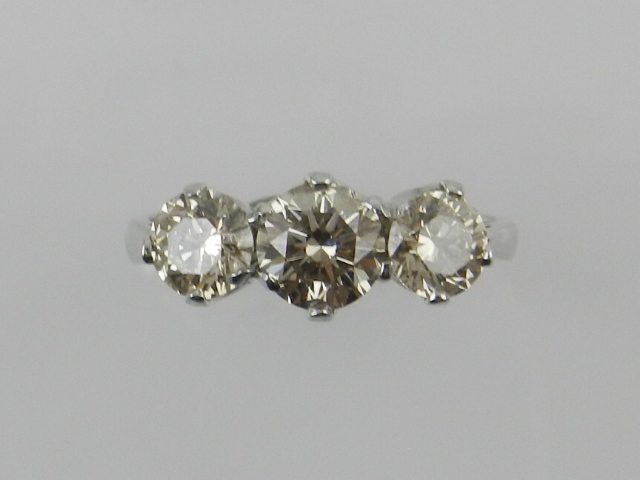 An 18 carat white gold and diamond three stone dress ring, the stones of approx. 1.84 carats