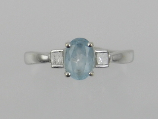 An white metal, diamond, and blue topaz