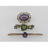 A yellow metal and amethyst set brooch,