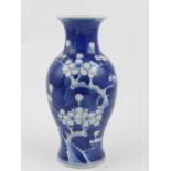 A Chinese blue and white porcelain vase, decorated with a flowering prunus tree.  H.14cm