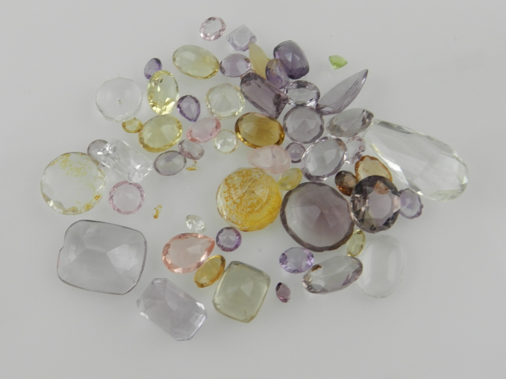 A collection of faceted semi precious stones and synthetics, to include pink, purple, lemon and