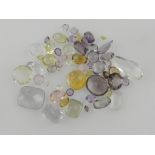 A collection of faceted semi precious stones and synthetics, to include pink, purple, lemon and