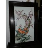 A Chinese hard paste porcelain plaque, polychrome decorated in enamels with songbirds amongst a