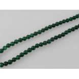 A green hardstone beaded necklace.