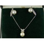 A white metal and pearl set pendant, the