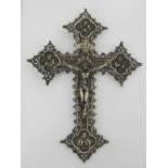 A continental white metal hand cross, decorated with saints and the Corpus Christi H.21cm