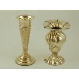 An early 20th century silver vase, emobossed with scrolls, flowers and foliage, stamped GH Sheffield