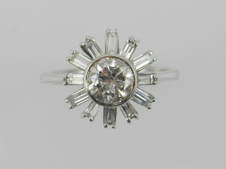 A white metal and diamond set starburst