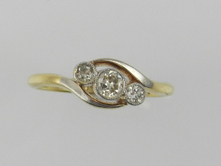 An 18 carat yellow gold three stone diam