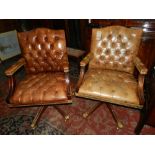 Two brown leather upholstered swivel des