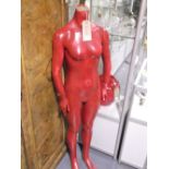 A red full size mannequin of female form.