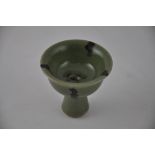 A celadon glazed stem cup, the centre with a moulded tortoise, H. 8cm.