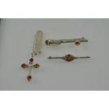 A white metal cross, with amber at the points, stamped 925, on a fine link chain; together with a