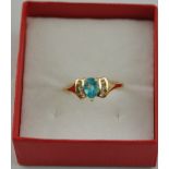 A dress ring, set with a pear-shaped blue stone flanked by white stones, on 9ct gold band, 2.5g.