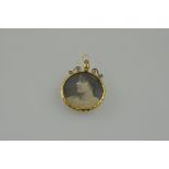 A Victorian yellow metal double-sided locket, 6.5g.