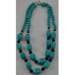 A two-row graduated onyx and turquoise necklace, L. 46cm.