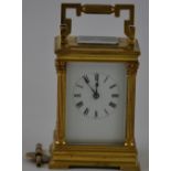 An early 20th Century carriage clock, the case with fluted acanthus columns, the white enamel dial