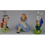 A group of three Alton Ceramics figures from Alice in Wonderland including Alice, The White Rabbit
