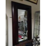 A large rectangular wall mirror with hardwood cushion frame aroudn a bevelled plate, H. 218cm.