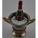 A limoges porcelain ornament modelled as a champagne bottle in an ice bucket, H. 7cm.