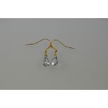 A pair of aquamarine drop earrings, on white metal frames and yellow metal hooks, 1g.