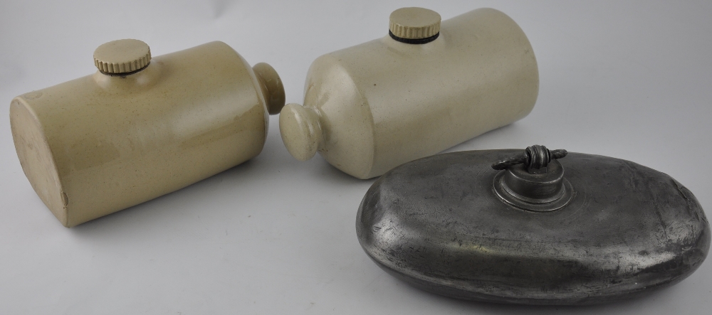 Two stoneware hotwater bottles, together with a similar pewter example, (3)